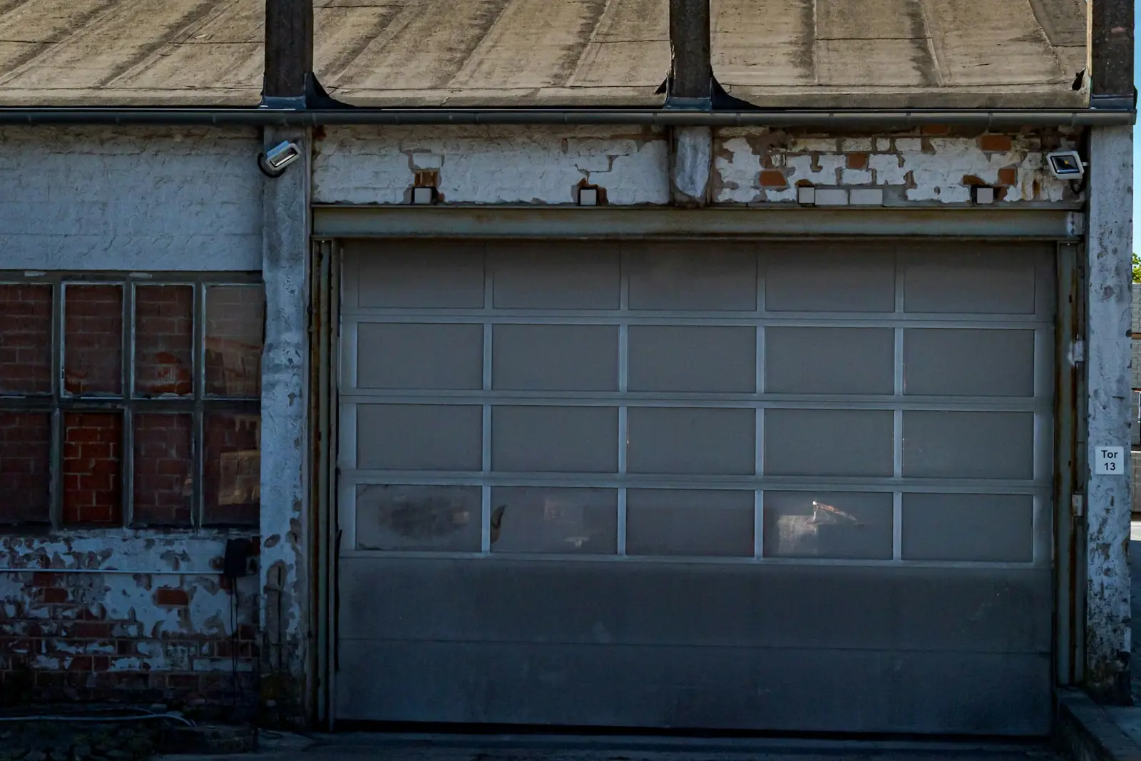 Detached garage with a weathered concrete slab and apron behind a home in Clawson, MI